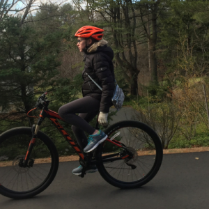girl with diabetes rides her bike with no hands