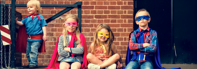 boys and girls dressed up as superheroes