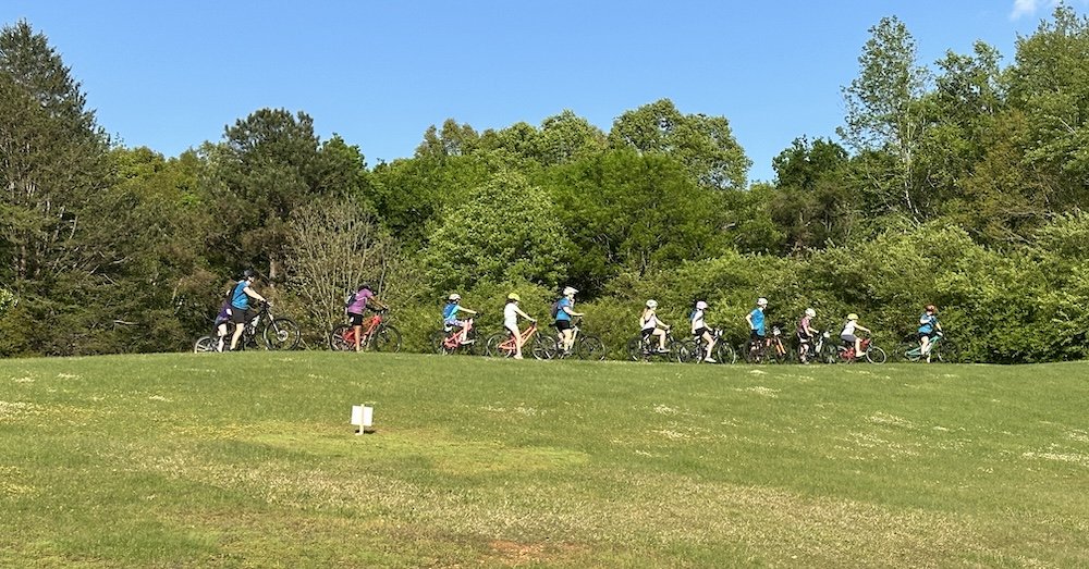 Tuscaloosa, Alabama Little Bellas ride single file across a grassy field