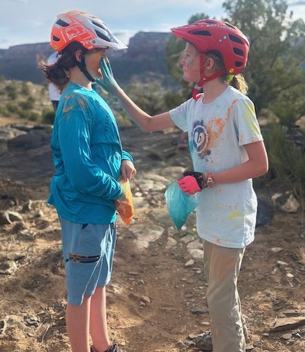 "You missed a spot." A Little Bella applies blue powder to her friend's face.